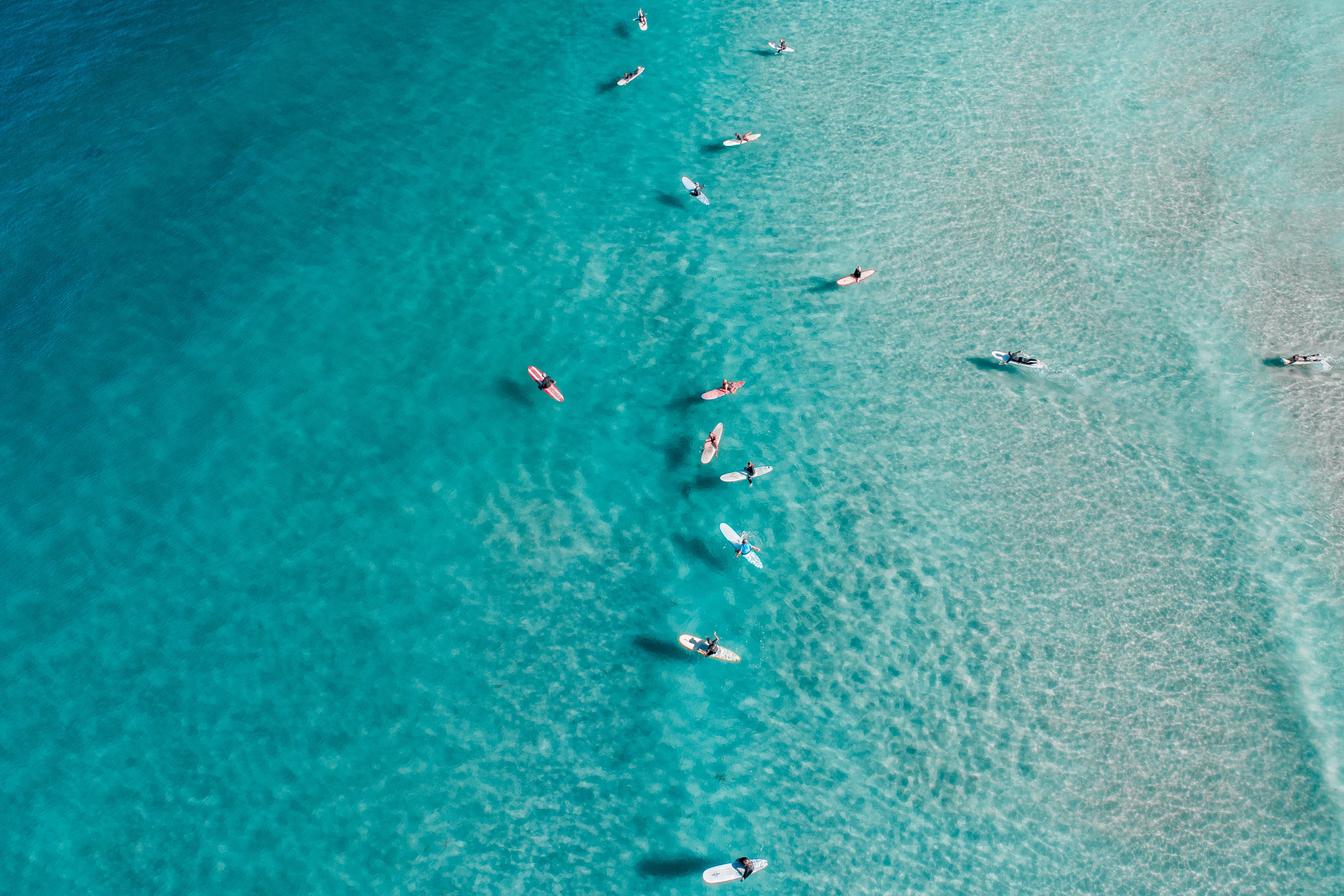 Aerial surf lineup in clear turquoise water